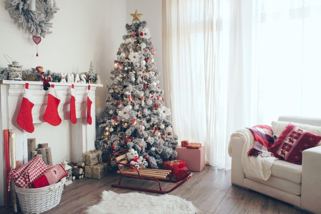 Beautiful holiday decorated room with Christmas tree with presents under it